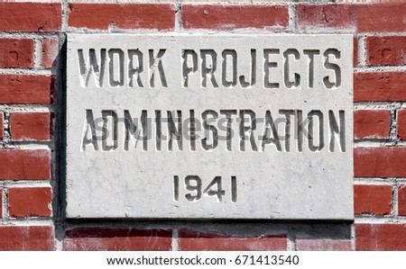 1941 Work Projects Administration concrete plaque attached to vintage brick public building.
