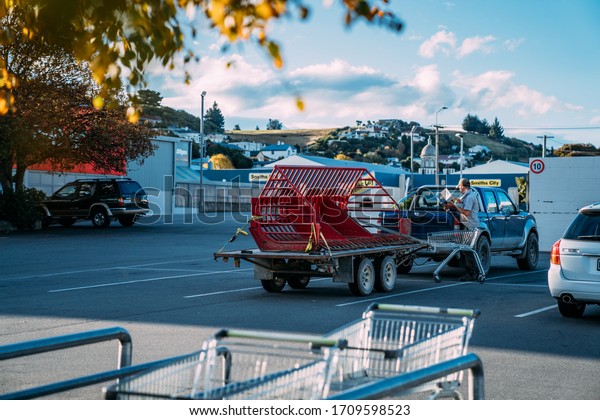 19/4/2020\
Oamaru, New Zealand. People unloading the stuff from supermarket to\
the car during the coronavirus\
pandemic.