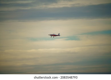 a 1951 De Havilland DHC-1 Chipmunk WD363 22 C-N C1-0304 flies low overhead in a blue and grey cloud winter sky