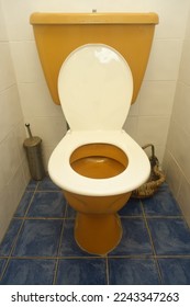1960s white and yellow mustard coloured bathroom toilet - Shutterstock ID 2243347263