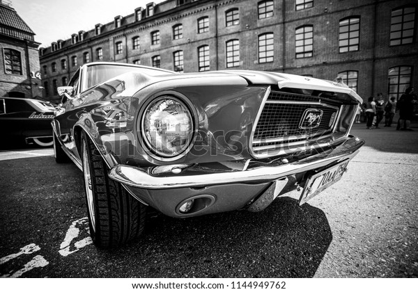 1965 Ford Mustang on the\
Custom Convention festival. Black and white. July 29, 2018, Moscow,\
Russia.
