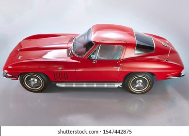 1966 Chevrolet Corvette Stingray Coupe Red On A Gray Background. Isolated