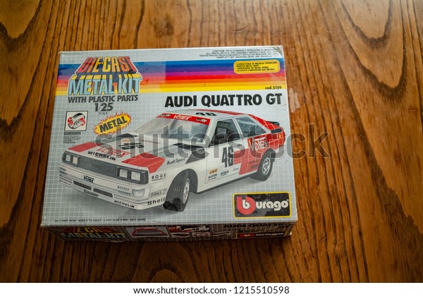 1980s Audi\
italian toy car kit with metal pieces. kitchen wood table inside a\
private apartment. Italy\
Europe