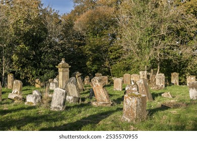 19th century church graveyard with weathered and falling sandstone headstone tombstones gravestones - Powered by Shutterstock