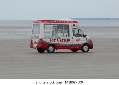 19th May 2019- A 1989 Ford ice cream van being driven on the sandy beach at Pendine, Carmarthenshire, Wales, UK