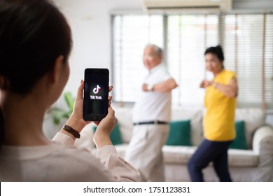 1-Jun-2020, Bangkok, Thailand : Asian Woman Using Mobile Phone Take Video Clip Of Senior People Dancing To Share On Tiktok Application