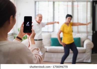 1-Jun-2020, Bangkok, Thailand : Asian Woman Using Mobile Phone Take Video Clip Of Senior People Dancing To Share On Tiktok Application