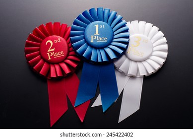 1st, 2nd And 3rd Place Pleated Ribbon Rosette On A Dark Background