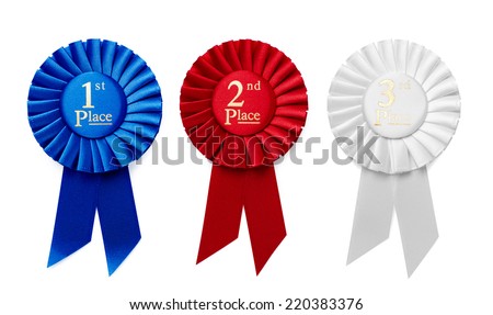 1st, 2nd and 3rd Place pleated ribbon rosettes or badges in blue, red and white respectively with central text isolated in a row on a white background, overhead view