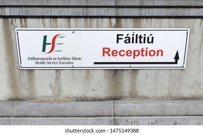 1st August 2019, Drogheda, County Louth, Ireland. HSE Reception Entrance Wall Sign In English And Irish Language. 