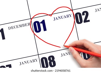 1st Day Of January. A Woman's Hand Drawing A Red Heart Shape On The Calendar Date Of 1 January. Heart As A Symbol Of Love. Winter Month. Day Of The Year Concept