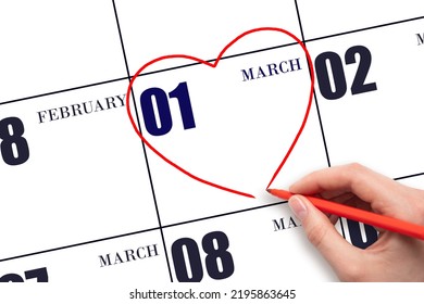 1st Day Of March. A Woman's Hand Drawing A Red Heart Shape On The Calendar Date Of 1 March. Heart As A Symbol Of Love. Spring Month. Day Of The Year Concept