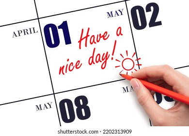 1st Day Of May. The Hand Writing The Text Have A Nice Day And Drawing The Sun On The Calendar Date May 1. Save The Date. Spring Month, Day Of The Year Concept.