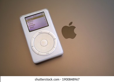 A 1st generation iPod laying on top of a Macbook laptop . Originally released October 2001. January 21, 2021. San Francisco, CA