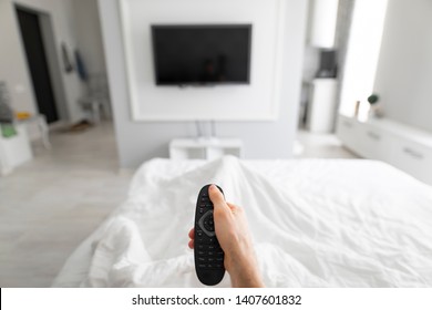 1st Person View Man Using TV Remote In A Bed