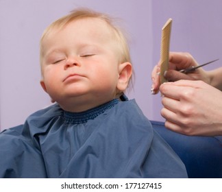 1-year boy first haircutting on violet background