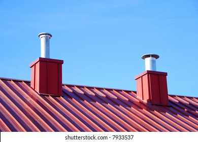 2 air vents on top of a red roof