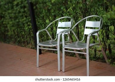 2 Aluminum Chairs Placed In The Garden