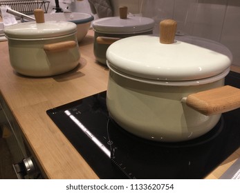 2 ceramic pots. Set of Kitchen Utensil, stainless kitchen ware hang on wall with plate and glasses.