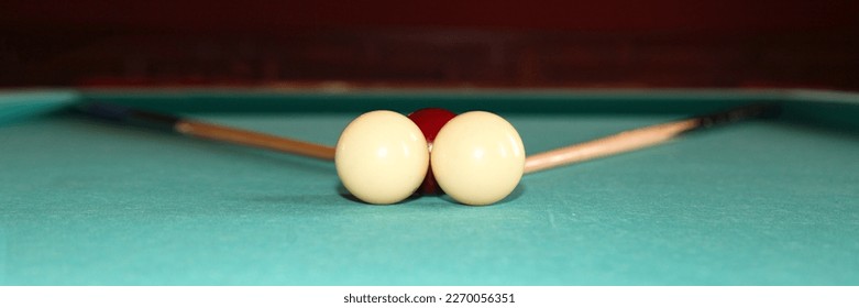 2 cues and 3 balls on a carom billiard table