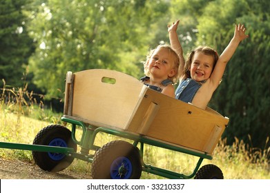 2 Cute little girls in a cart