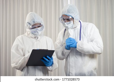 2 doctor wearing face shield and Personal Protective Equipment, PPE suit, health care worker hard work at hospital - Shutterstock ID 1771028573