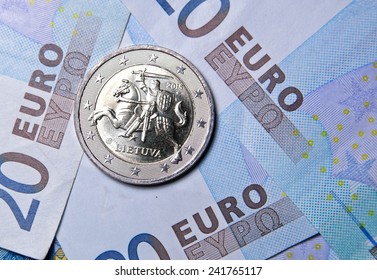 2 euro coin of Lithuania over euro banknotes