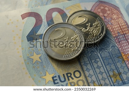 2 Euro coins on a banknote. Proof European coins.