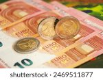 2 euro coins on euro banknotes. Business and finance.