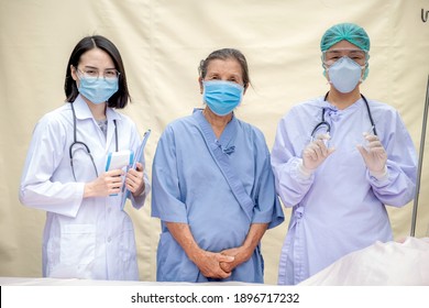 2 Female doctors and senior patients standing at the field hospital and wore masks due to the COVID 19 epidemic, health medical checkup concept.