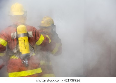 2 Firemen In Operation Surround With Smoke