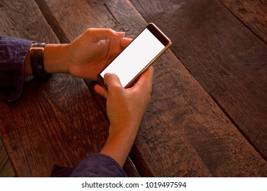 2 hand control mobile on wooden table.
