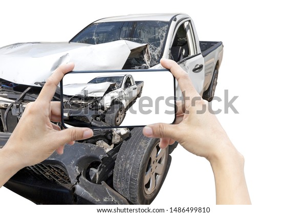 2 hand of woman hold\
smartphone for take photo of front white color car accident. Save\
with cliping path