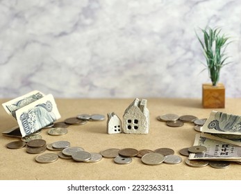2 household items and money around - Shutterstock ID 2232363311