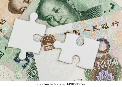 2 Jigsaw Puzzle On Chinese Yuan Banknotes Using As China Economics, Tariff Or Trade War Negotiation Future Direction Between The US And China Concept.