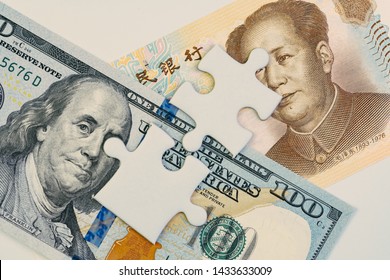 2 Jigsaw Puzzle On US America Dollar And Chinese Yuan Banknotes Using As Tariff Or Trade War Negotiation Or Future Direction Between The US And China Concept.