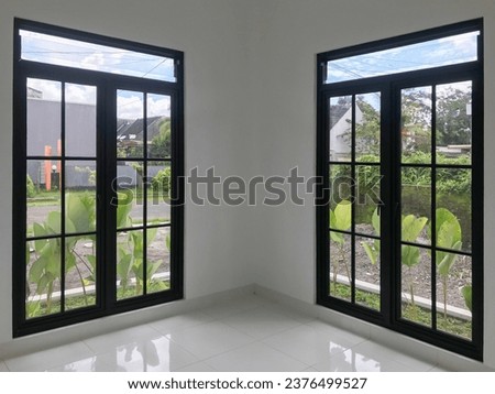 2 large checkered windows with black aluminum frames.