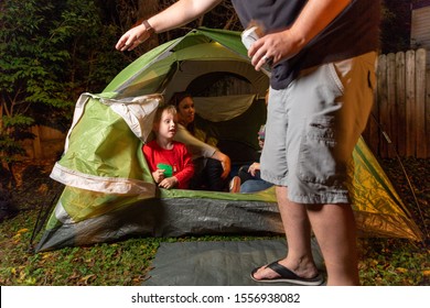 2 Little Boys Play Together With Their Moms In Their Backyard In A Green Camping Tent At Night