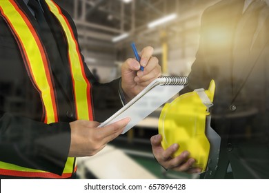 2 male occupational health and safety officer inside factory doing inspection - Shutterstock ID 657896428