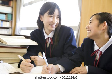 2 Middle School Girls Studying In A Library