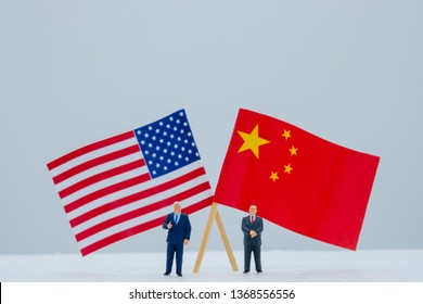 2 Miniature Figure With USA And China Flags. Its Is Symbol For Tariff Trade War Crisis Or Unfair Business Of 2 Biggest Economic Countries In The World.