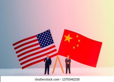 2 Miniature Figure With USA And China Flags. Its Is Symbol For Tariff Trade War Crisis Or Unfair Business Of 2 Biggest Economic Countries In The World.