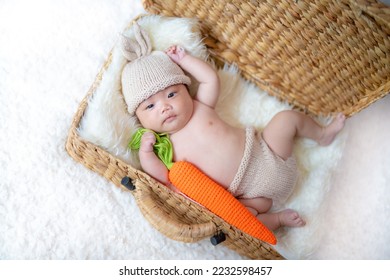 2 month old baby wearing bunny clothes - Shutterstock ID 2232598457