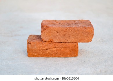 2 orange Bricks on a Cement Floor, Used for Construction of a house in India. This image is super crispy High Res and Royalty-Free. (Pic 2)