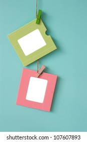 2 paper frames on blue wall background