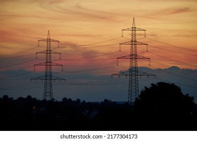 2 power pylons before sunset. Energy crisis in Europe because high electricity prices. Germany, Nurtingen.