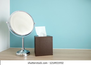 2 Sides magnify mirror and tissue box on the wooden desk.