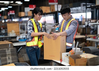 2 Staff Worker Working In The Large Depot Storage Warehouse Happy Smiling Packing Box At Cashier Counter