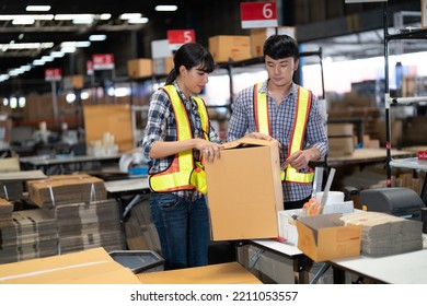 2 Staff Worker Working In The Large Depot Storage Warehouse Happy Smiling Packing Box At Cashier Counter