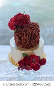 2 Tier Wedding Cake Decorated With Gold And Red Rosette Ruffles.